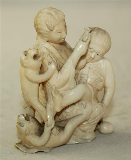 A Japanese ivory okimono of a mother suckling a child, Meiji period, 7.7cm